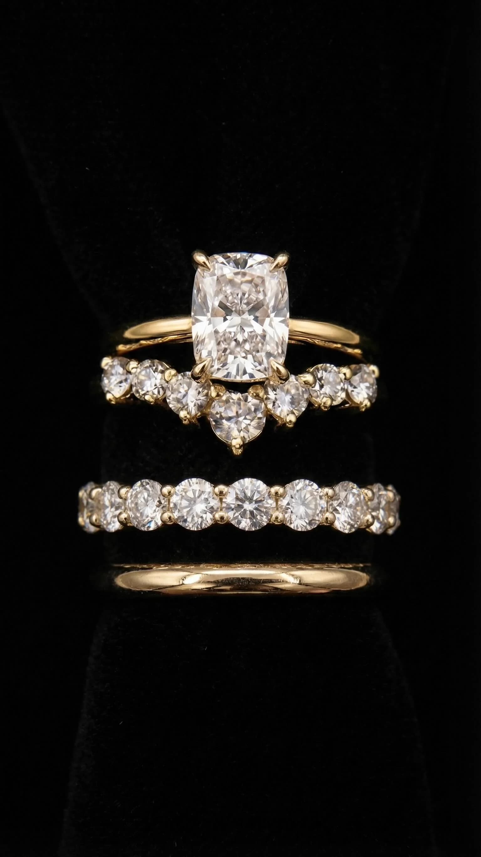 Elongated cushion cut diamond engagement ring stacked with a curved diamond wedding band, a round diamond band and a plain gold band, by Lily Dia Jewellery