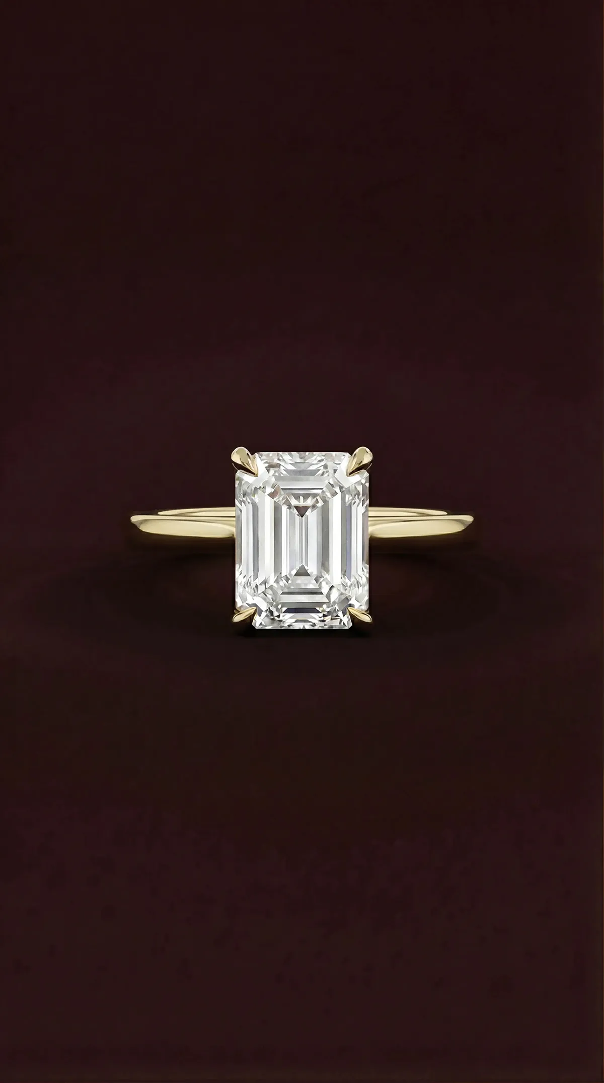Emerald cut lab-grown diamond solitaire engagement ring with four claws in yellow gold, by Lily Dia Jewellery