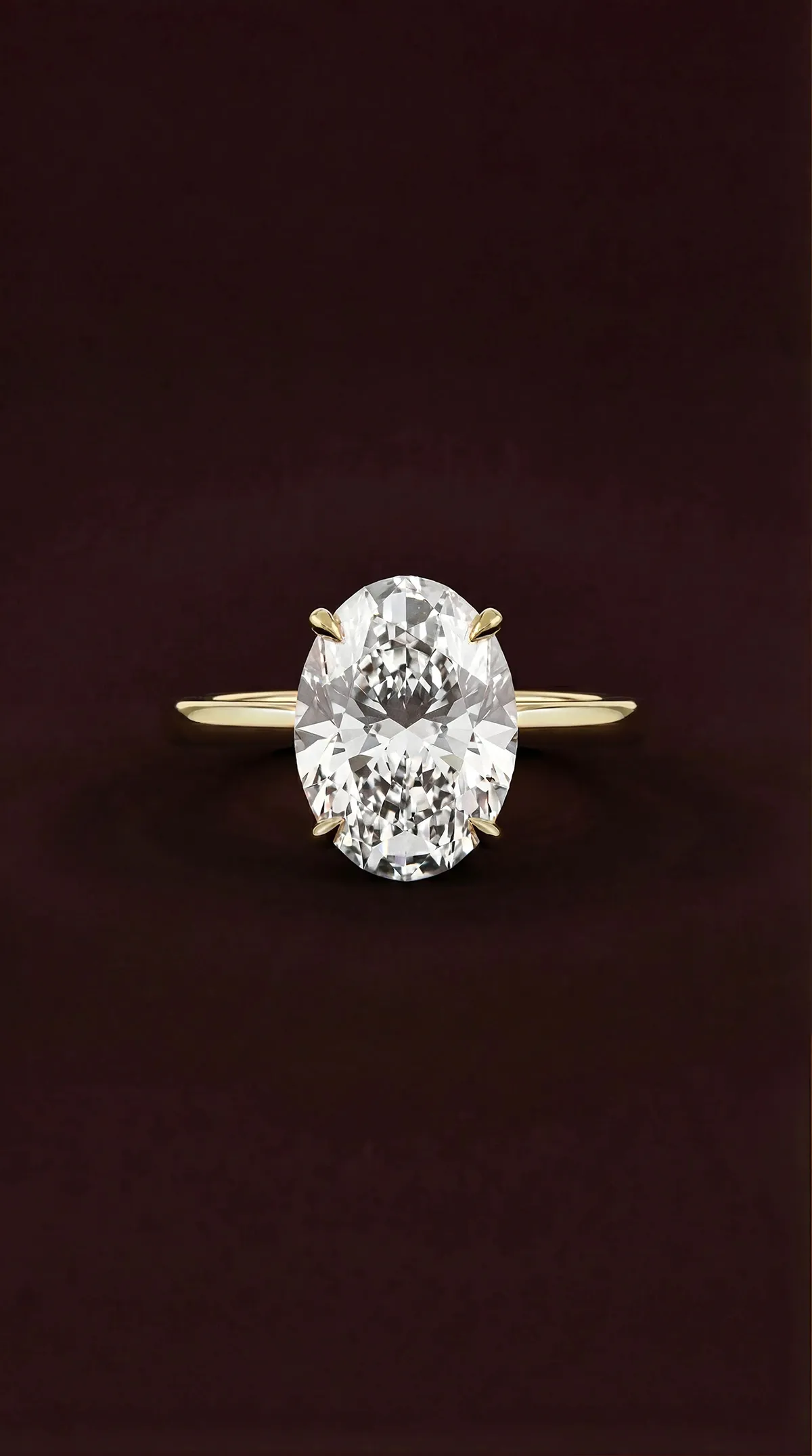 Oval lab-grown diamond solitaire engagement ring with four claws in yellow gold, by Lily Dia Jewellery