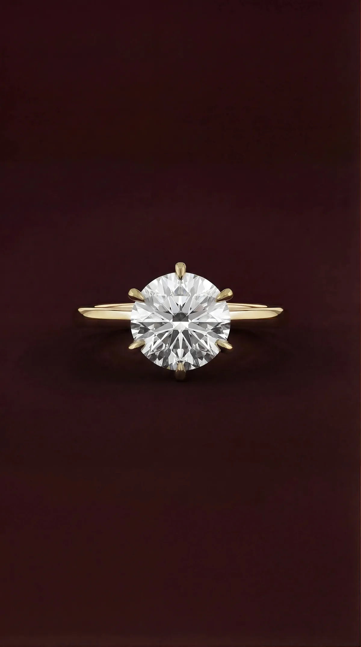 Round lab-grown diamond solitaire engagement ring with six claws in yellow gold, by Lily Dia Jewellery